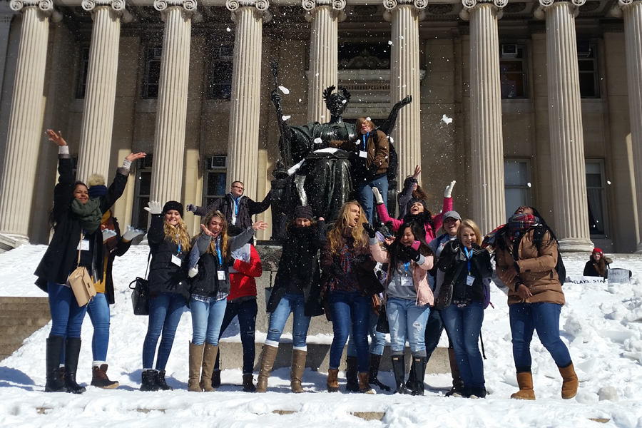 Broadcast journalism students gather together for a picture in front of the sculpture of the goddess Athena at Columbia Universitys Low Library.  The picture in front of the sculpture is a broadcast journalism tradition.